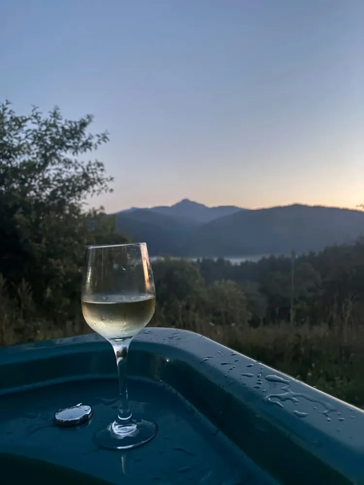 Pahar de vin la apus pe marginea jacuzzi-ului